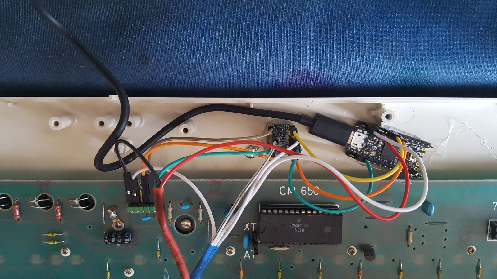 Figure 2: Controller and level shifter installed inside a Pravetz 16 keyboard. Except for the cable, the keyboard is 100% pristine. The old cable was connected to the PCB using headers, which made it extremely convenient to plug in the new circuits.
