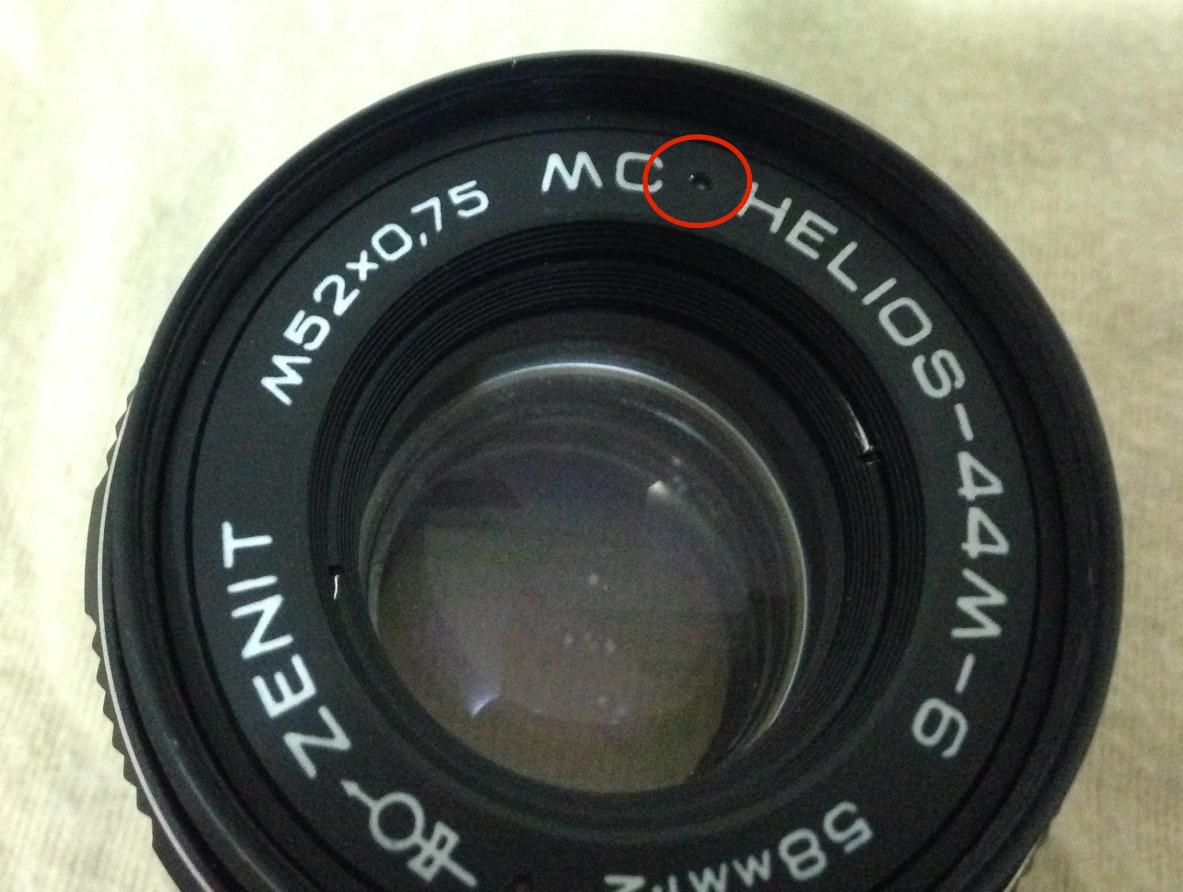 Figure 1: Lens front. Ring dent circled red.