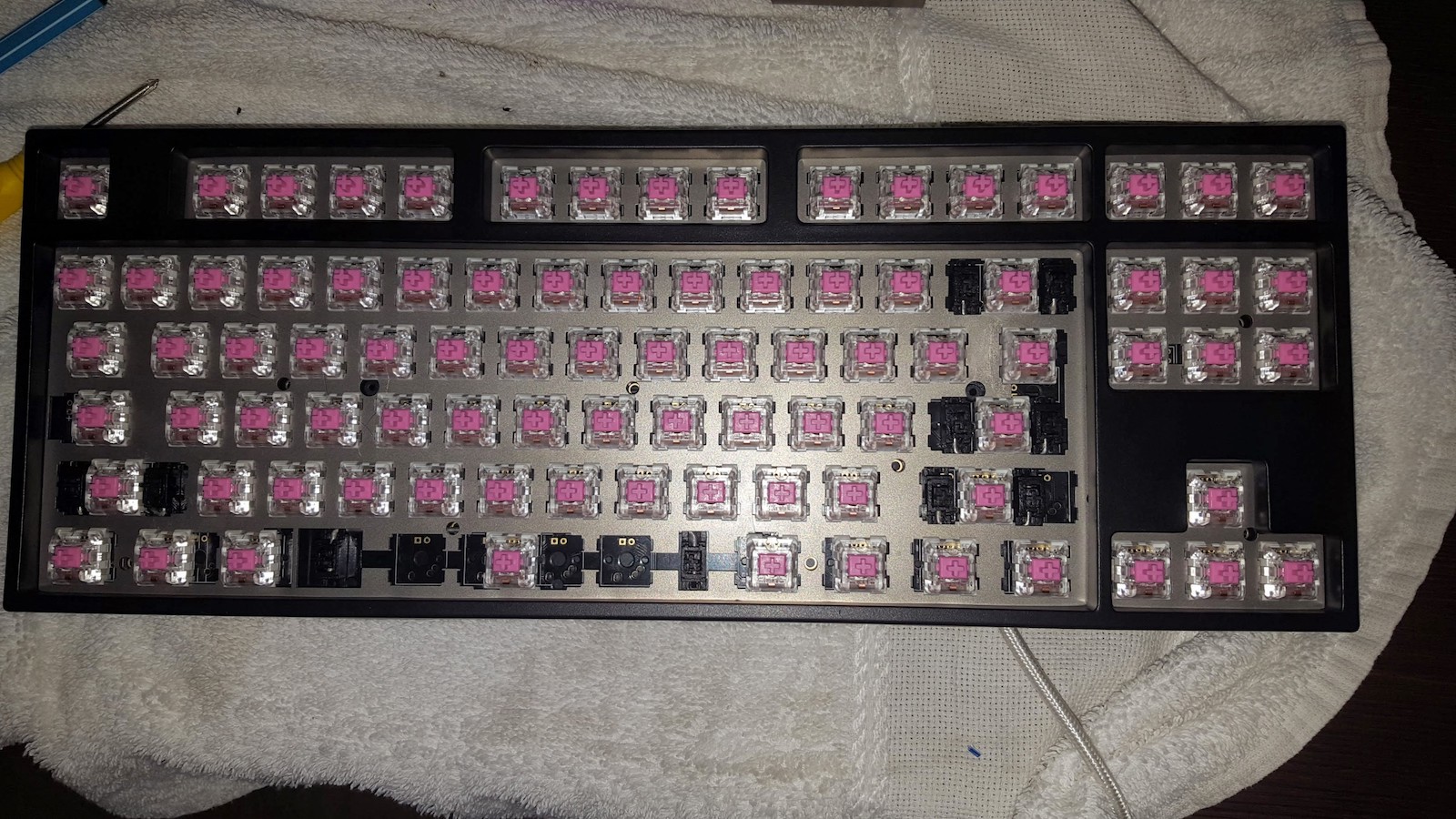 Figure 12: Keyboard with all switches soldered in place, top cover clamped in place.