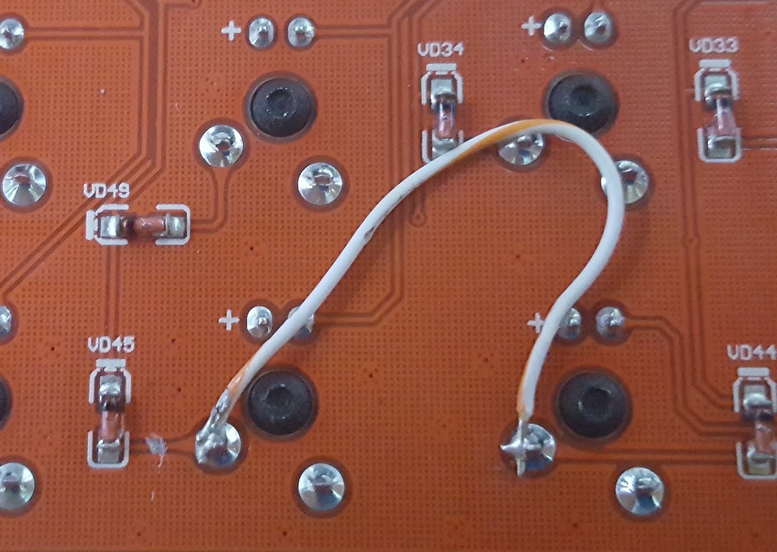 Figure 3: Changing the layout by brute force, cutting PCB tracks and bridging with wire. Three modifier keys were altered this way.