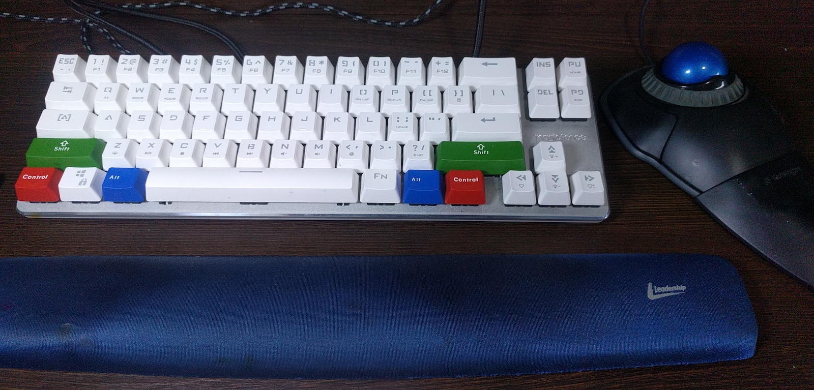 Figure 1: The setup that works best for me: nice trackball, wrist rest and 65% keyboard with `brown` switches.